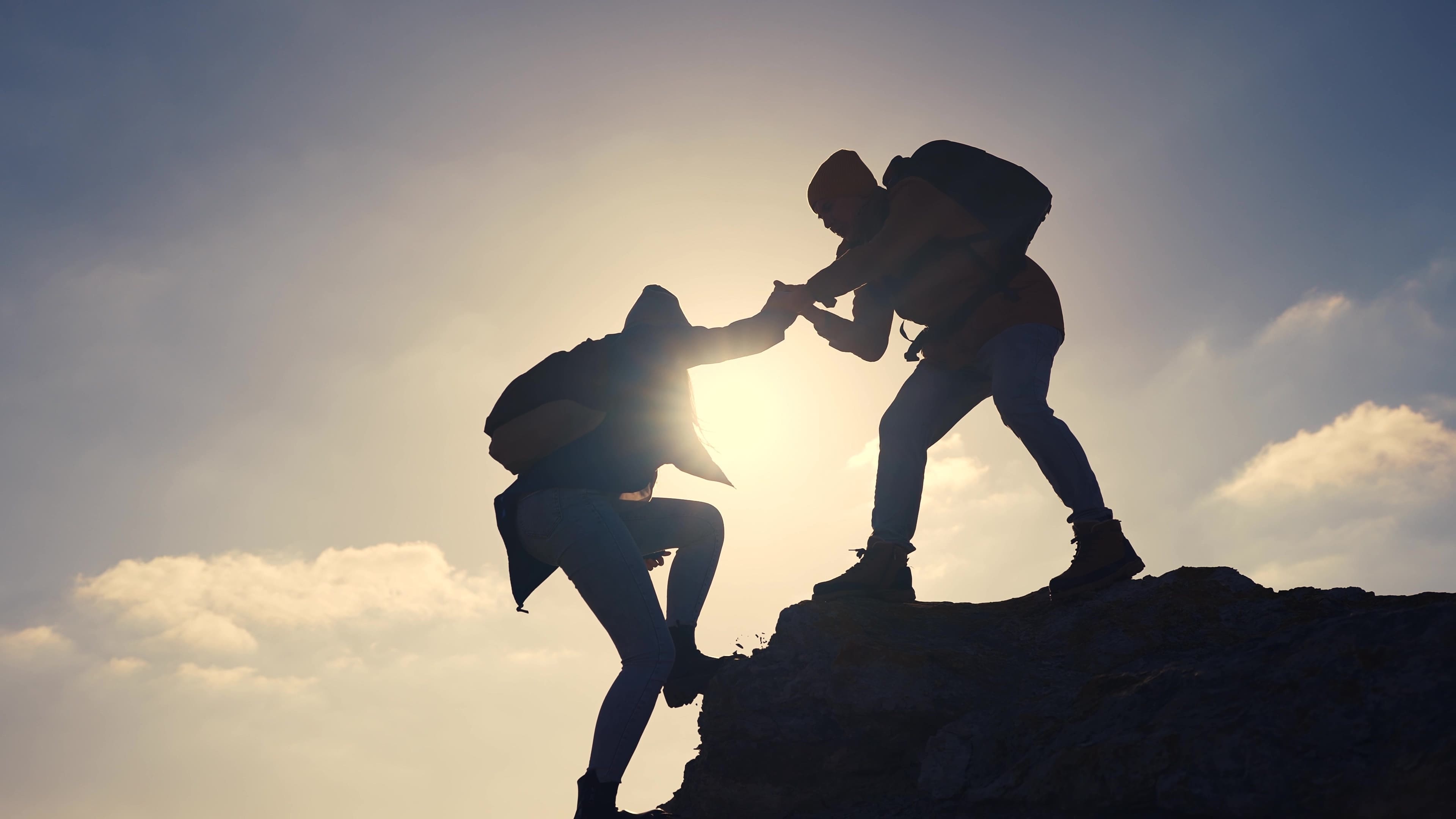 Teamwork and trust - people helping each other